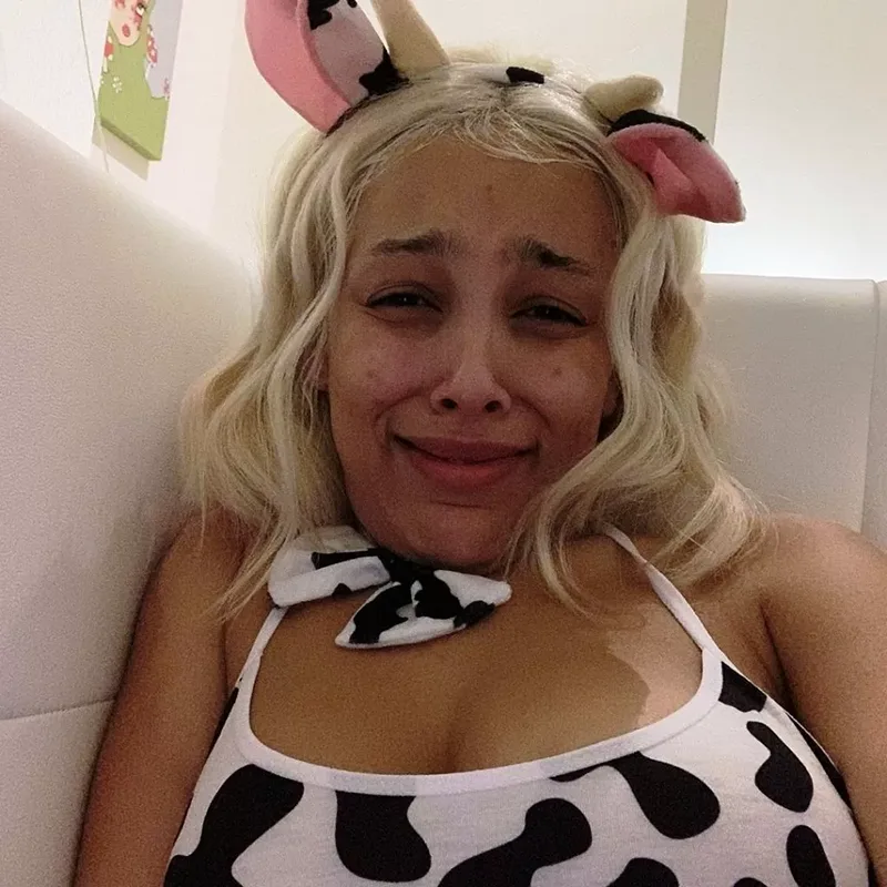 Doja Cat slaying a cow costume with no makeup on